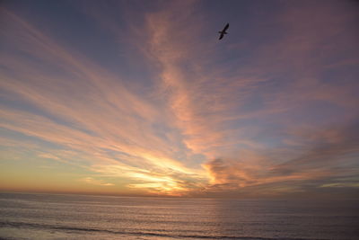 Scenic view of sea against orange sky
