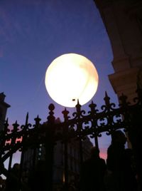 Low angle view of illuminated street light against sky