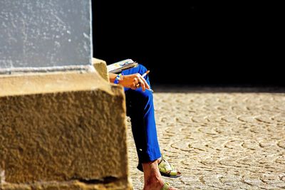 Low section of man standing on ground