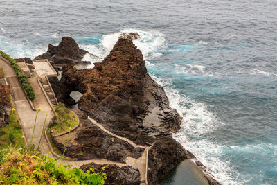 High angle view of rock formations at sea shore