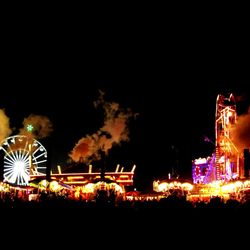 Illuminated ferris wheel at night