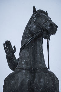 Statue against sky during winter