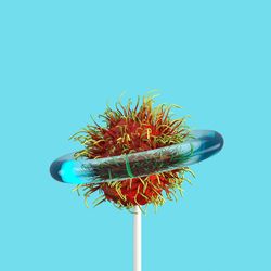 Close-up of rambutan candy against blue background