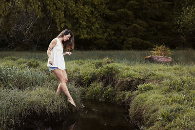 Natural beauty with tattoos in a meadow in ucluelet