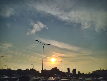 Traffic on road at sunset