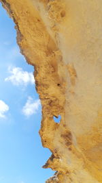 Low angle view of rock against sky