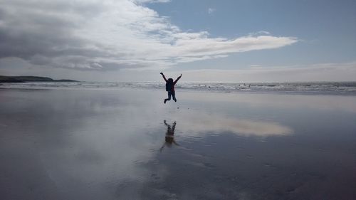 Man on beach against sky