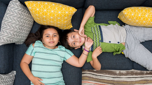 Portrait of friends lying on floor