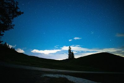 Scenic view of silhouette mountains against sky at night