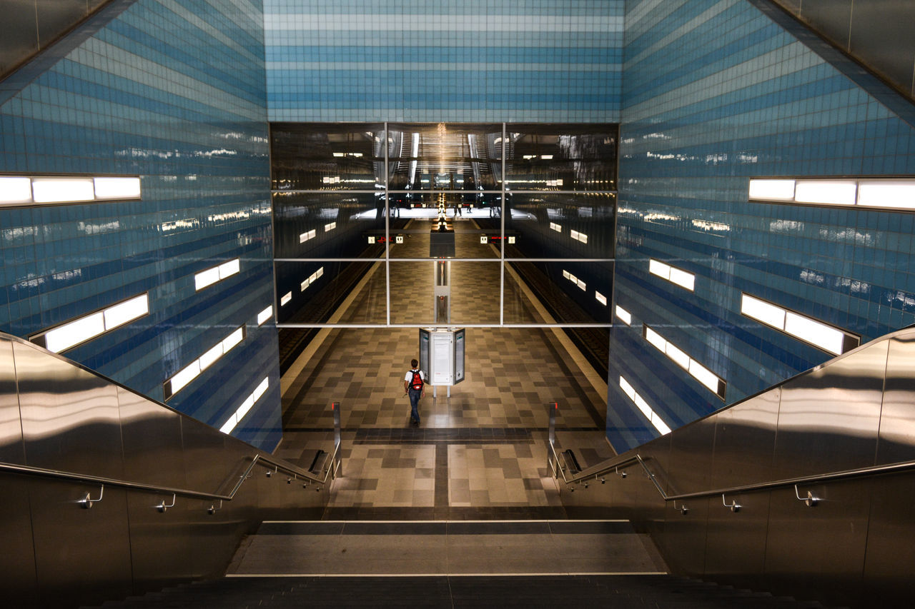 HIGH ANGLE VIEW OF PEOPLE WALKING IN AIRPORT