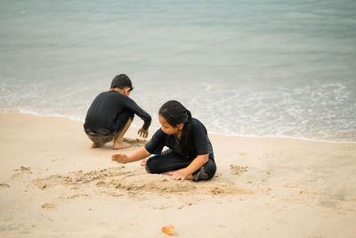 Rear view of people on beach