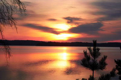 Scenic view of lake against romantic sky at sunset