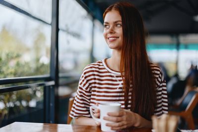 Portrait of young woman sitting at cafe