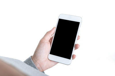 Close-up of hand holding smart phone over white background