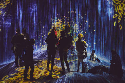 Group of people standing at night