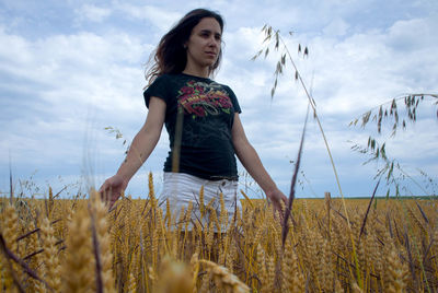 Woman standing in field against sky