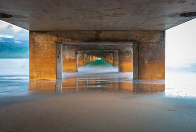 Interior of bridge over sea, underneath hanalei pier in hanalei bay, kauai early in the morning