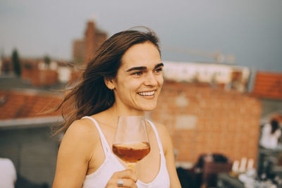 Portrait of a smiling young man drinking glass