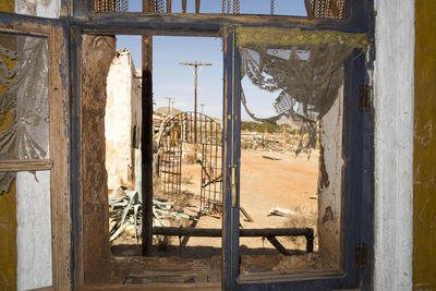 Abandoned building seen through glass window