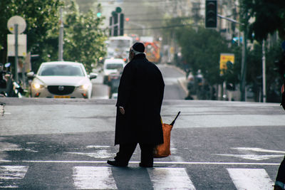 Rear view of man walking on street