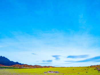 Scenic view of landscape against blue sky