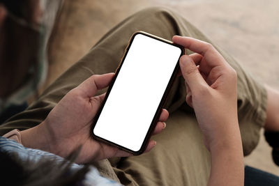 Midsection of man using mobile phone