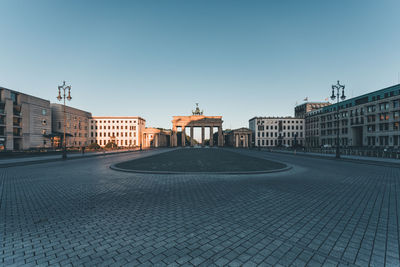 Buildings in city against clear sky