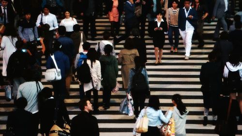 High angle view of people walking on staircase