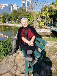 Portrait of smiling young woman sitting outdoors