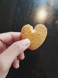 Close-up of hand holding heart shape cookies