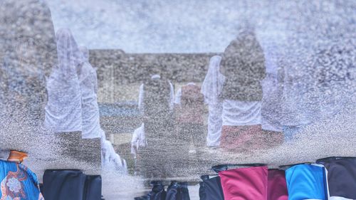 Low section of people on wet beach