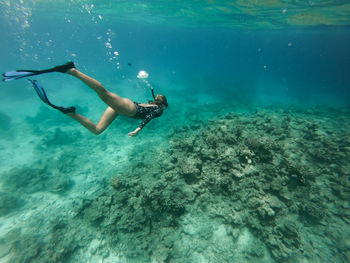 Mid adult woman swimming in sea