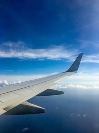 Airplane wing against sky