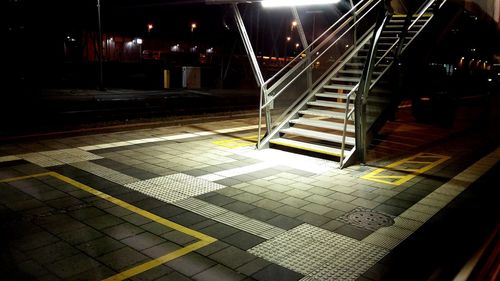 Illuminated walkway at night