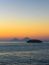 Scenic view of sea against clear sky during sunset