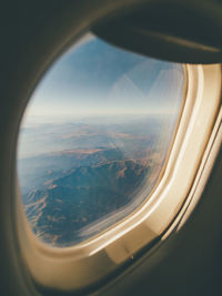 Aerial view of landscape seen through airplane window