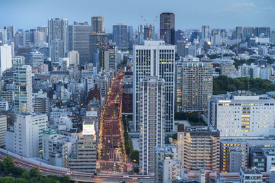 Aerial view of tokyo modern buildings in city against sky