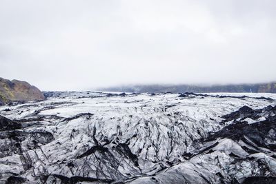 Close-up of frozen landscape against sky