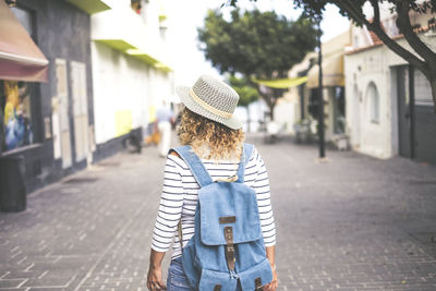 Rear view of woman standing on street