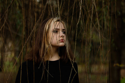 Close-up of woman looking away standing outdoors