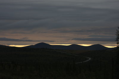 Scenic view of silhouette mountains against sky at sunset