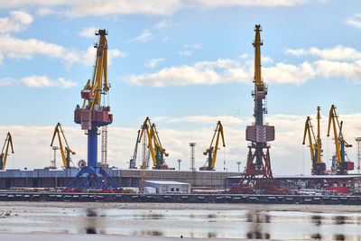 Massive harbor cranes in seaport. heavy load dockside cranes in port, cargo container ship terminal