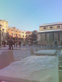 People in city against clear sky