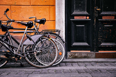 Bicycle parked against wall