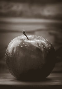 Close-up of wet apple on table