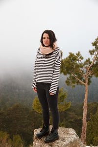 Portrait of young woman wearing striped top during foggy weather