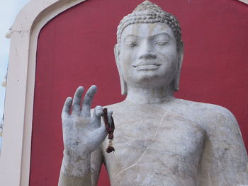 Close-up of statue against red wall