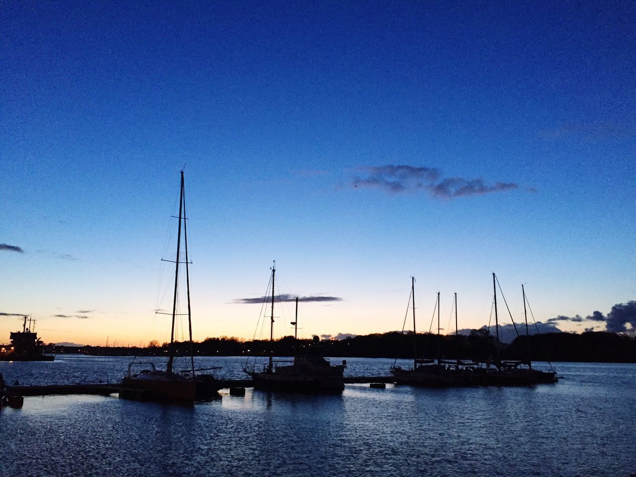 SAILBOATS MOORED ON SEA