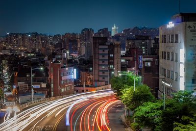 Light trails on road in city at night