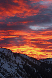 Scenic view of snowcapped mountains against sky during sunset